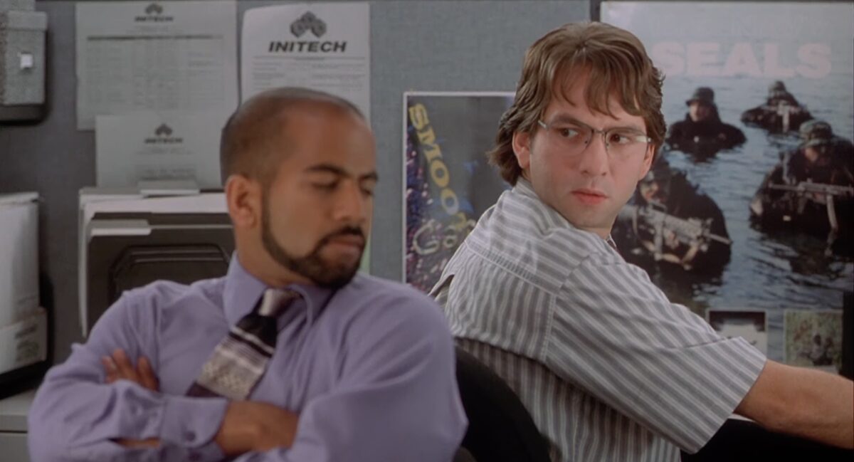 still from the film office containing two people sitting next to each other